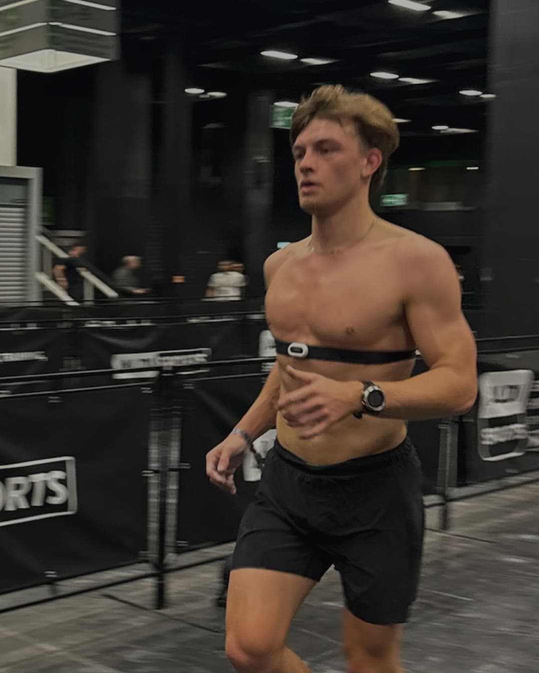 Hyrox athlete running with a heart rate strap